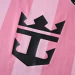 Close-up of Inter Miami CF 2025/26 home jersey featuring a black anchor and crown emblem on pink fabric.