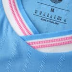 Close-up of Inter Miami CF 2025/26 Third Player Version jersey collar in light blue with pink and white stripes.