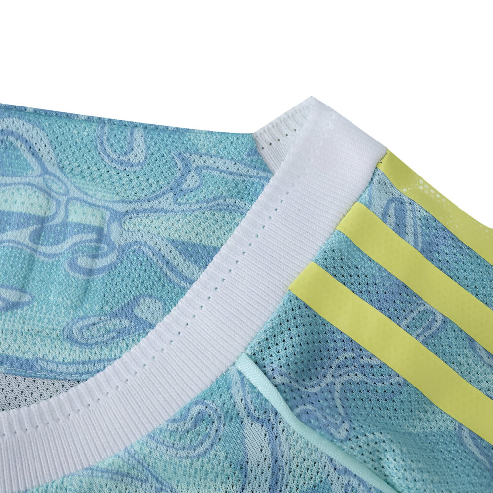 Close-up of Juventus Away 2025/26 Player Version jersey collar with yellow stripes and blue pattern.