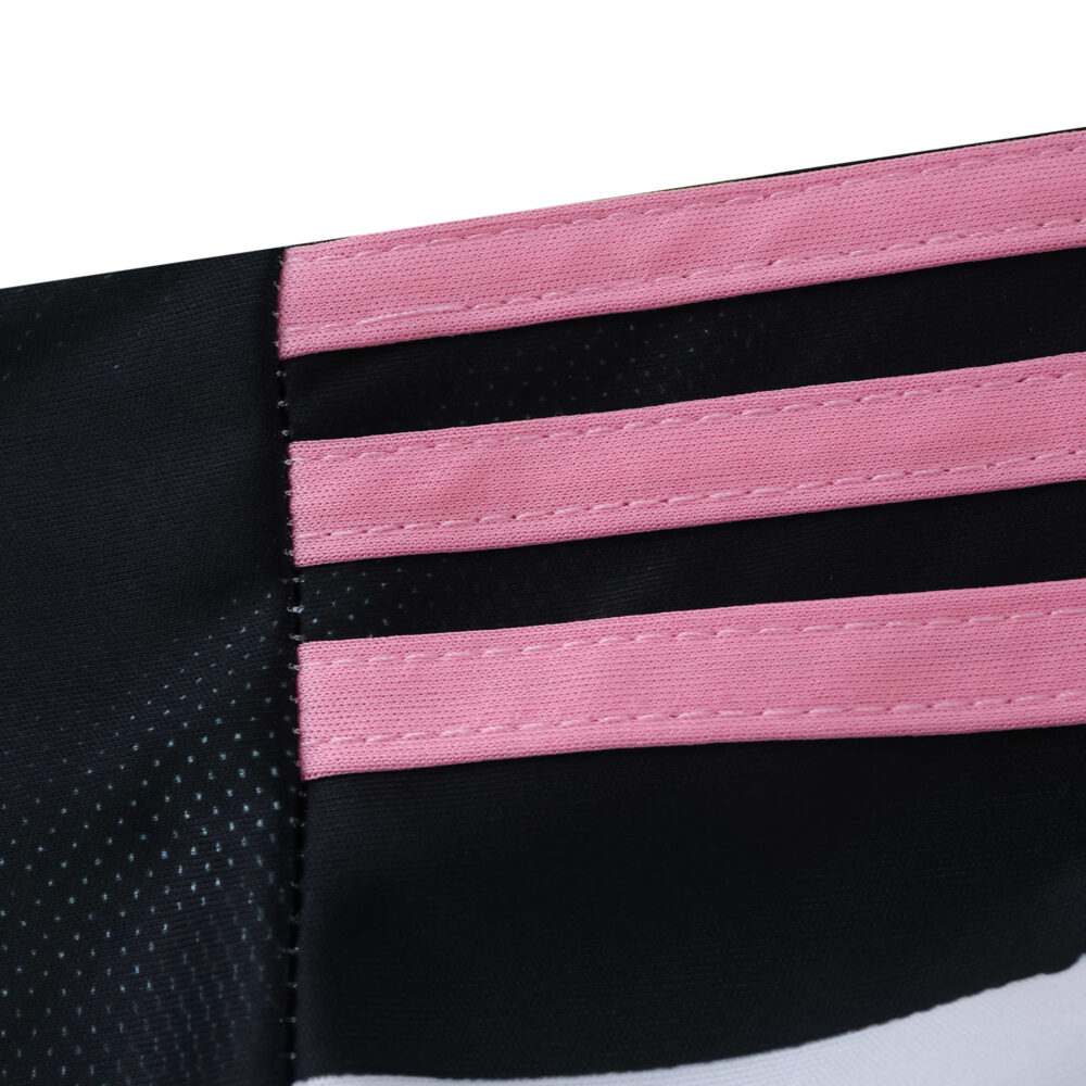 Close-up of Juventus 2025/26 Home Fan Version jersey with pink Adidas stripes on black fabric.