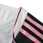 Close-up of the Juventus 2025/26 Home Player Version jersey featuring white and black fabric with pink stripes.