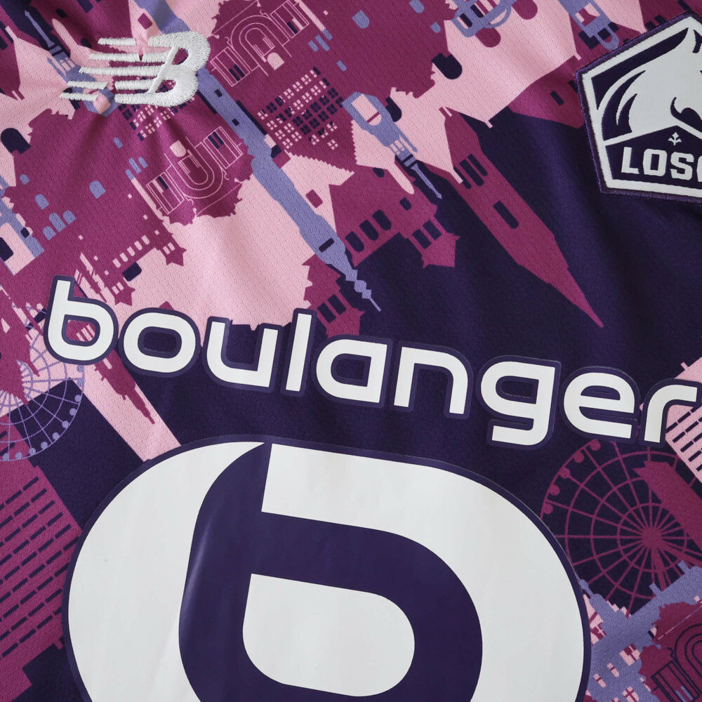 Close-up of Lille LOSC 2025/26 away fan jersey featuring sponsor logos and cityscape pattern in pink and purple.