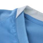 Close-up of collar detail on Manchester City 2025/26 Home Player Version jersey in light blue fabric.