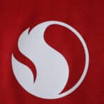 Close-up of the 2025/26 Manchester United Home Player Version jersey featuring a bold white abstract logo.