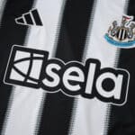 Close-up of the Newcastle United 2025/26 home fan jersey with club crest and sponsor logo.