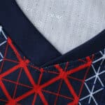 Close-up of the Paris Saint-Germain 2025/26 Home Player Version jersey collar with red and blue geometric pattern.