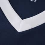 Close-up of the PSV Eindhoven 2025/26 away fan jersey, showing the white V-neck collar detail.