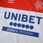 Close-up of Rangers Away 2025/26 Fan Version jersey showing sponsor and club logo details.