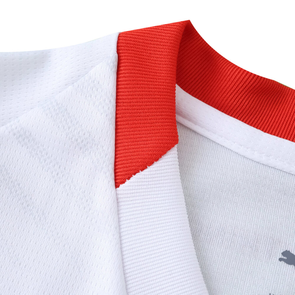 Close-up of RB Leipzig Home 2025/26 fan jersey collar showing red and white fabric detail.
