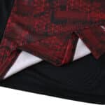 Close-up of the RB Leipzig Third 2025/26 Fan Version jersey showing red geometric patterns on dark fabric.