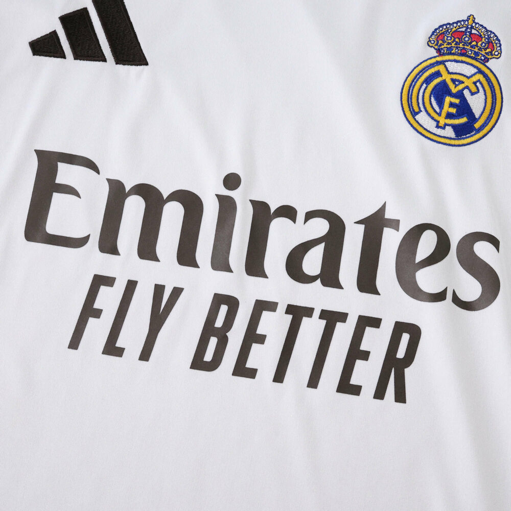 Close-up of the Real Madrid 2025/26 home jersey with club crest and "Emirates Fly Better" sponsor logo.