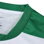 Close-up of the Sporting CP 2025/26 Home Fan Version jersey collar, featuring green and white details.