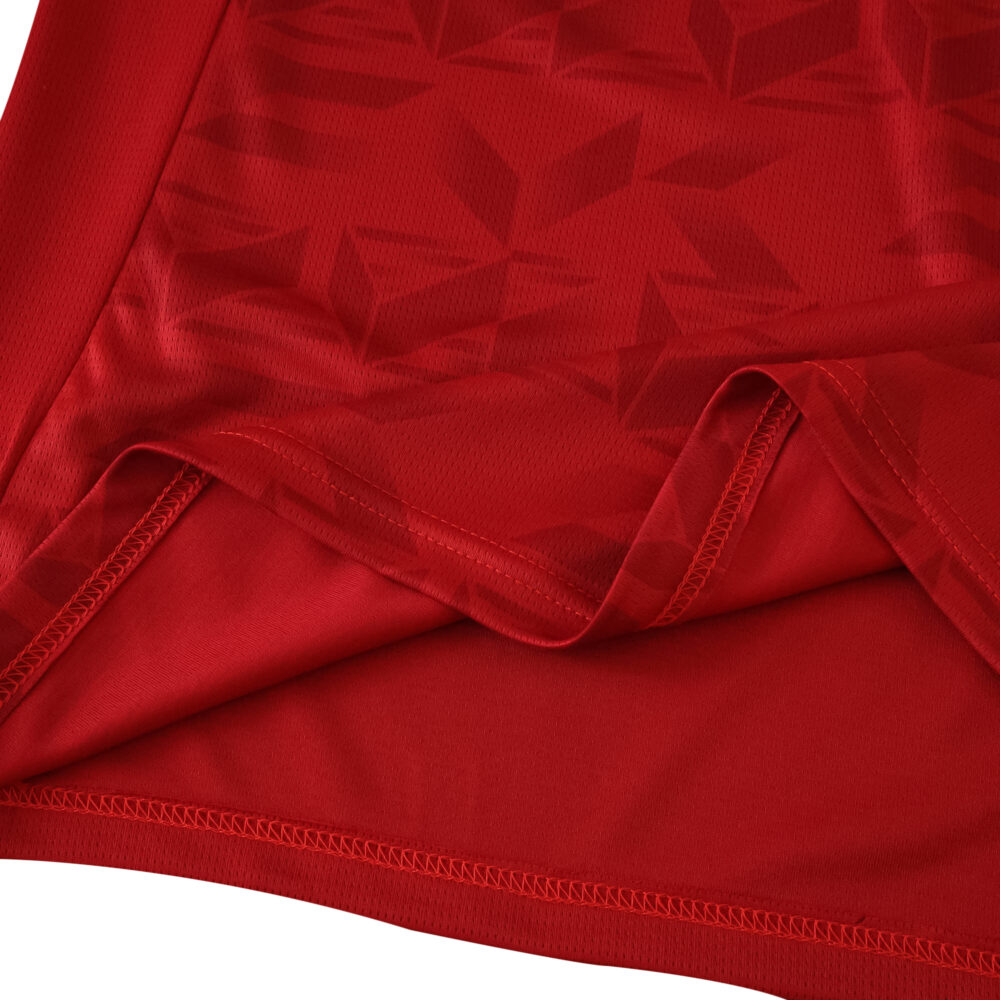 Close-up of the 2025/26 Valencia Away Fan Version jersey, showing red fabric with subtle geometric patterns.