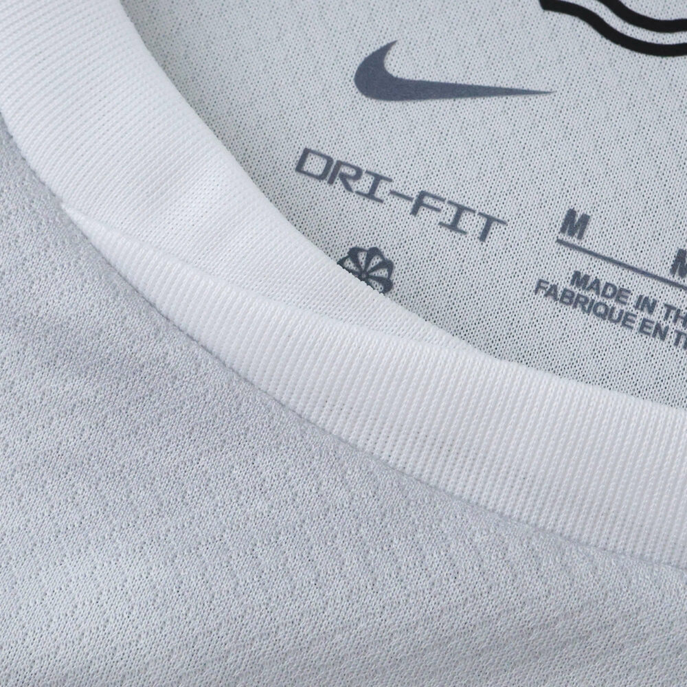 Close-up of the VfL Wolfsburg Away 2025/26 Fan jersey collar showing Dri-FIT label and logo.
