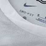 Close-up of the VfL Wolfsburg Away 2025/26 Fan jersey collar showing Dri-FIT label and logo.