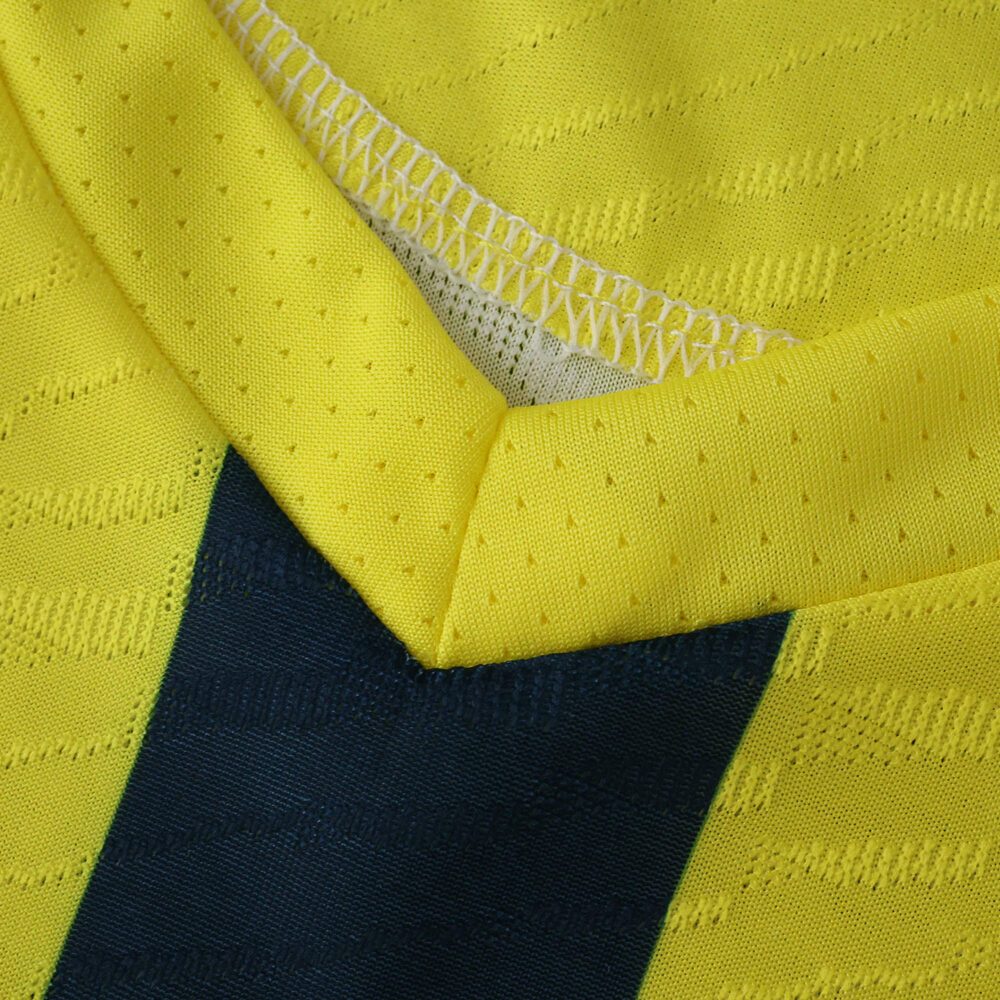 Close-up of Villarreal Home 2025/26 Player Version jersey collar showing yellow fabric and mesh detail.