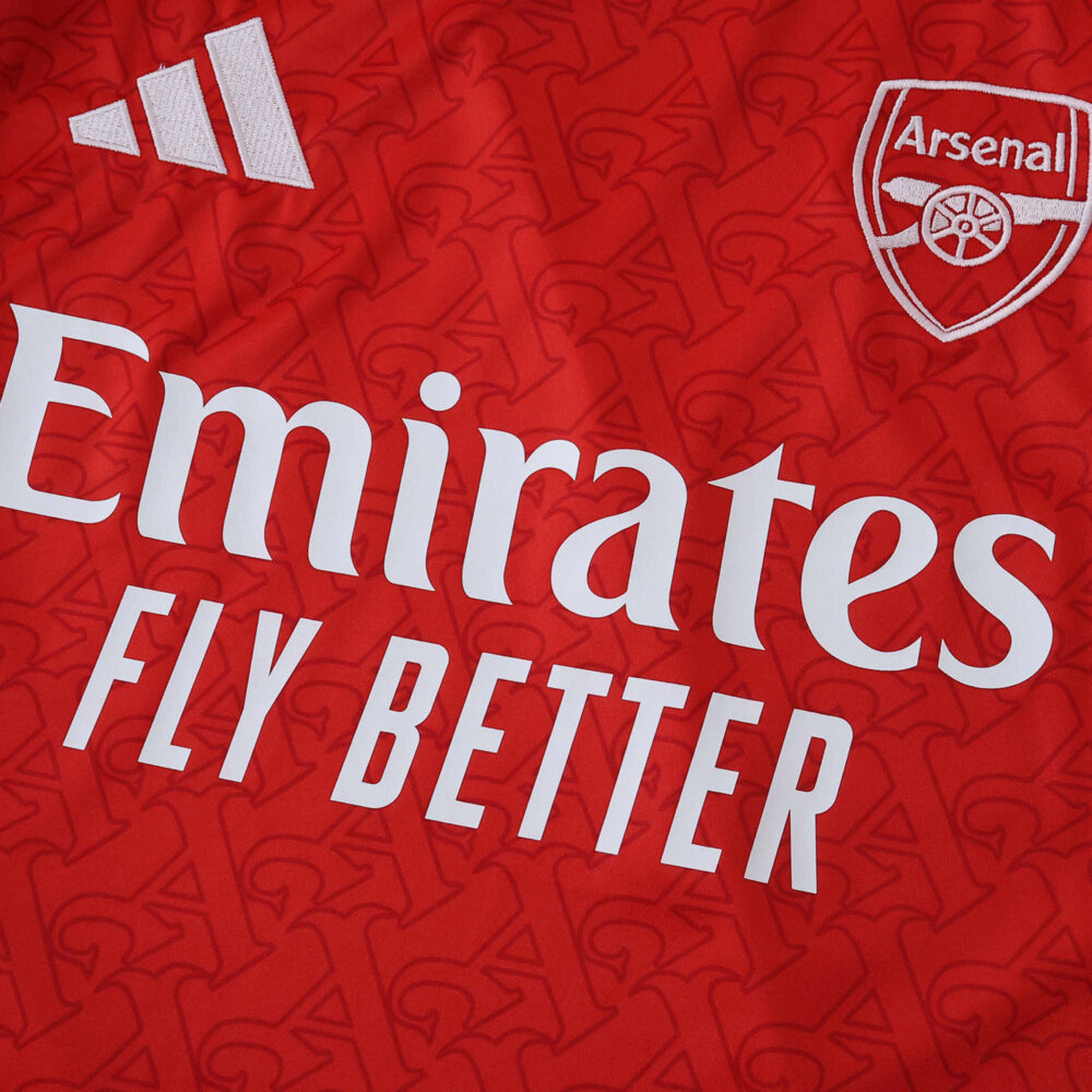 Close-up of the 2025/26 Arsenal Home Fan Version jersey featuring club crest and Emirates Fly Better sponsor.