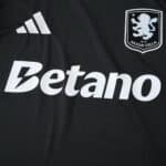 Close-up of Aston Villa Away 2025/26 Fan Version jersey showing club crest, sponsor, and adidas logo.