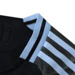 Close-up of Aston Villa Away 2025/26 Player Version jersey collar and shoulder with light blue stripes.