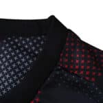 Close-up of Bayer Leverkusen 2025/26 home fan jersey collar with red and white X patterns.