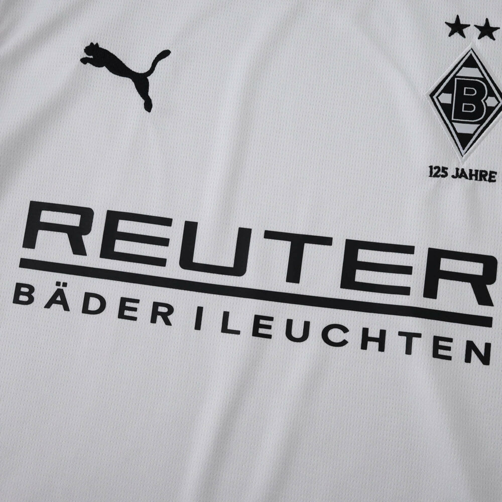Close-up of Borussia Monchengladbach 2025/26 home fan jersey with club logo, sponsor, and Puma branding.