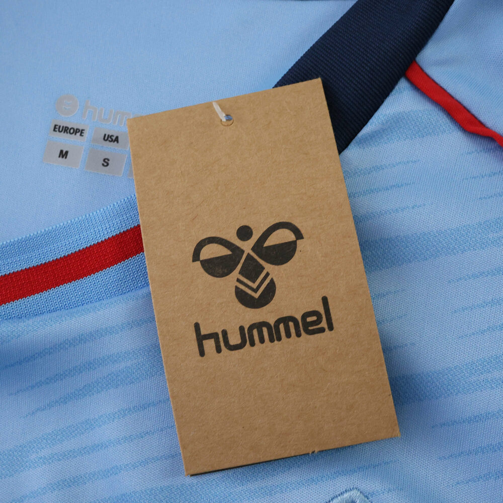 Close-up of the Celta Vigo 2025/26 Home Fan Version jersey with Hummel tag and size label visible.