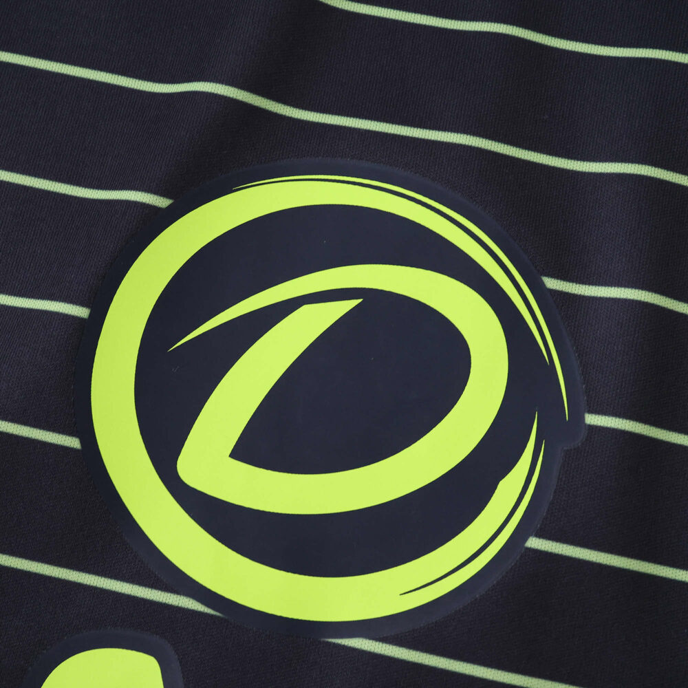Close-up of the Celtic Away 2025/26 Fan Version jersey featuring a neon yellow emblem and thin stripes.