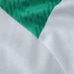 Close-up of the Celtic Home 2025/26 fan jersey showing green and white fabric details.