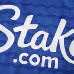Close-up of the Everton 2025/26 fan home jersey showing the "Stake.com" sponsor logo on blue fabric.