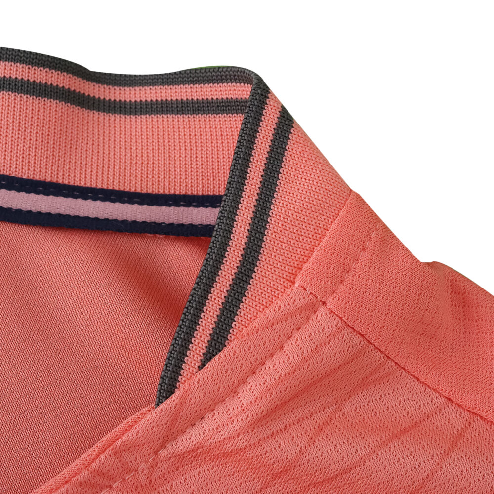 Close-up of the collar detail on the FC Porto Away 2025/26 Fan Version jersey in coral pink.