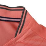 Close-up of the collar detail on the FC Porto Away 2025/26 Fan Version jersey in coral pink.