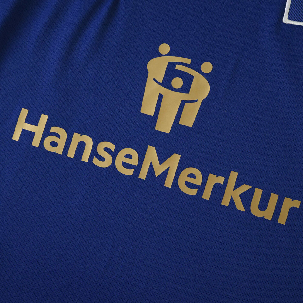 Close-up of the Hamburger SV 2025/26 away fan jersey featuring the HanseMerkur sponsor logo in gold.
