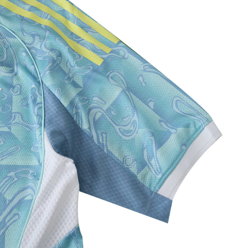 Close-up of Juventus Away 2025/26 Player Version jersey sleeve with intricate blue pattern and yellow stripes.