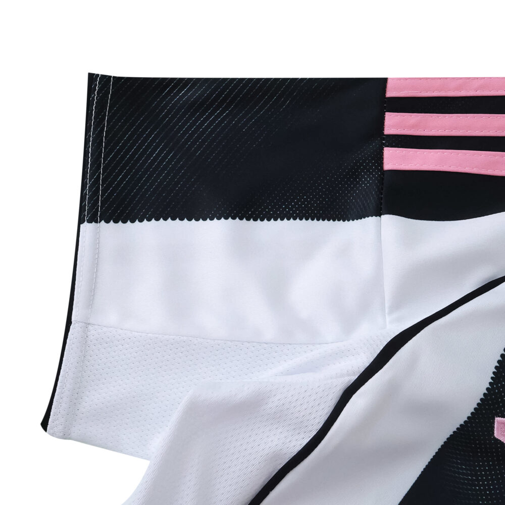 Close-up of Juventus Home 2025/26 Fan Version jersey fabric, showing black, white, and pink details.