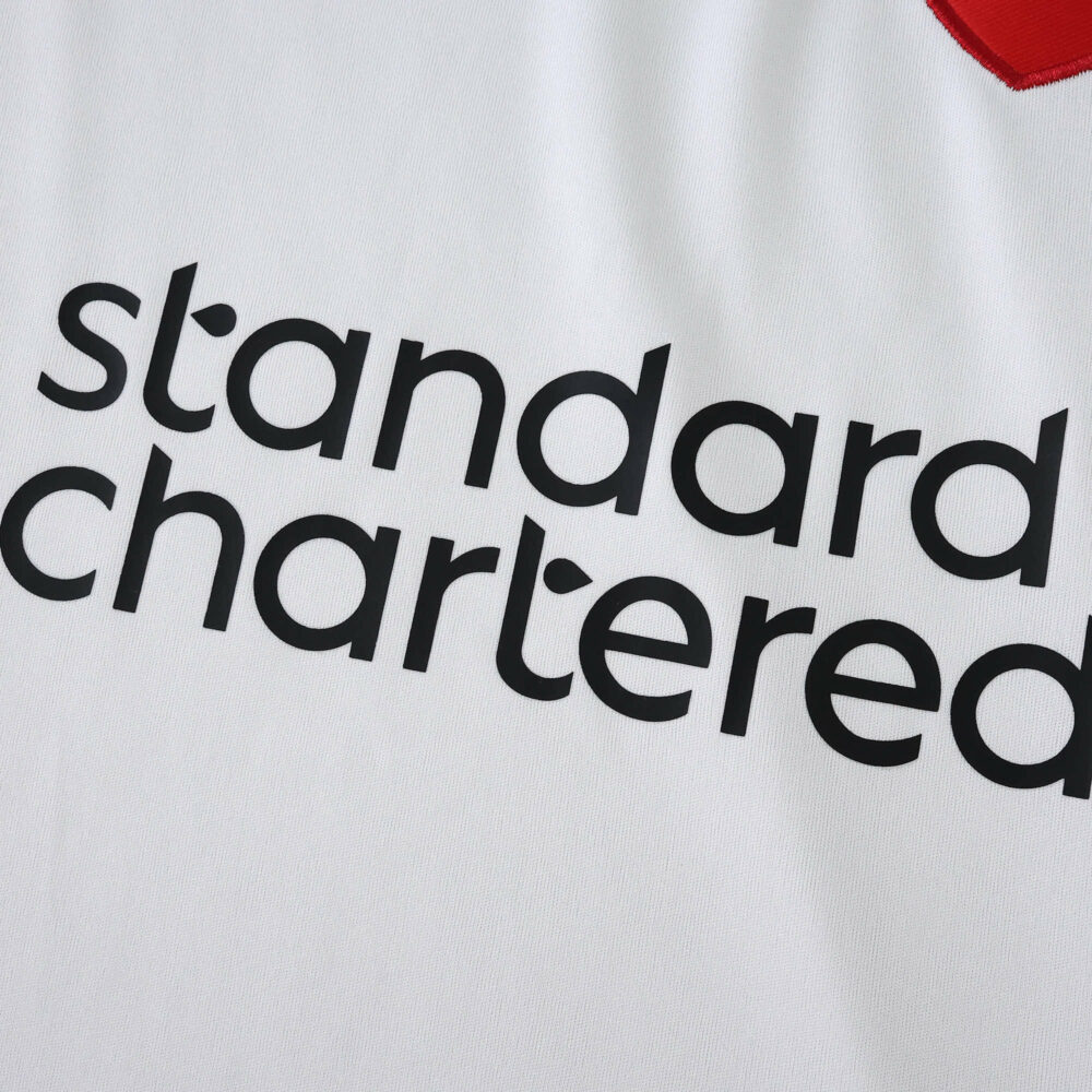 Close-up of the Standard Chartered logo on the Liverpool 2025/26 Away Fan Version jersey.