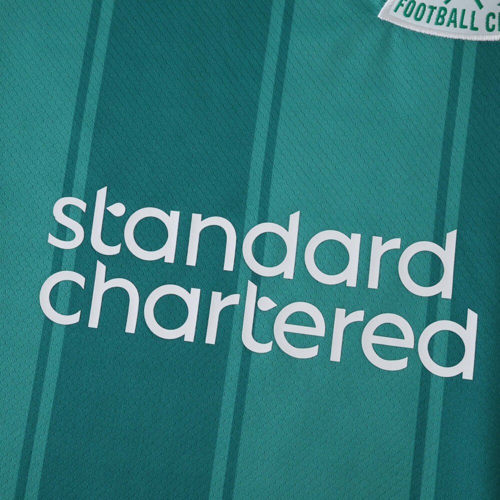 Close-up of Liverpool Third 2025/26 Fan Version jersey featuring the Standard Chartered sponsor logo.