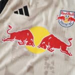 Close-up of New York Red Bulls Away 2025/26 player jersey featuring the Red Bull logo and club badge.