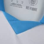 Close-up of Olympique Marseille 2025/26 home fan jersey collar with light blue and white fabric details.