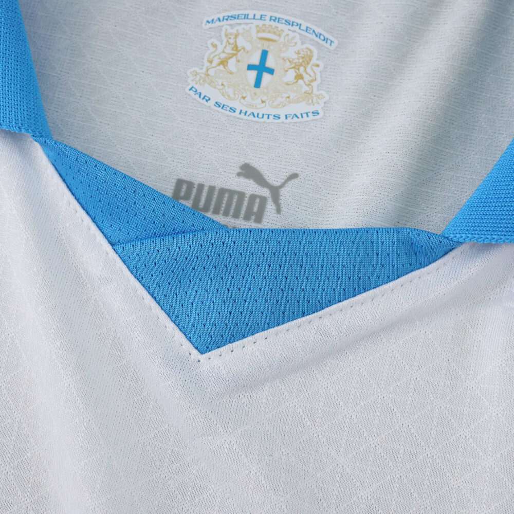 Close-up of Olympique Marseille 2025/26 Home Player Version jersey collar with Puma logo and club crest.