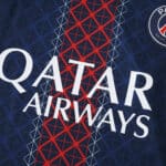 Close-up of PSG 2025/26 home fan jersey with Qatar Airways sponsor and club badge visible.