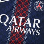 Close-up of PSG 2025/26 Home Player Version jersey showing club crest and Qatar Airways sponsor logo.