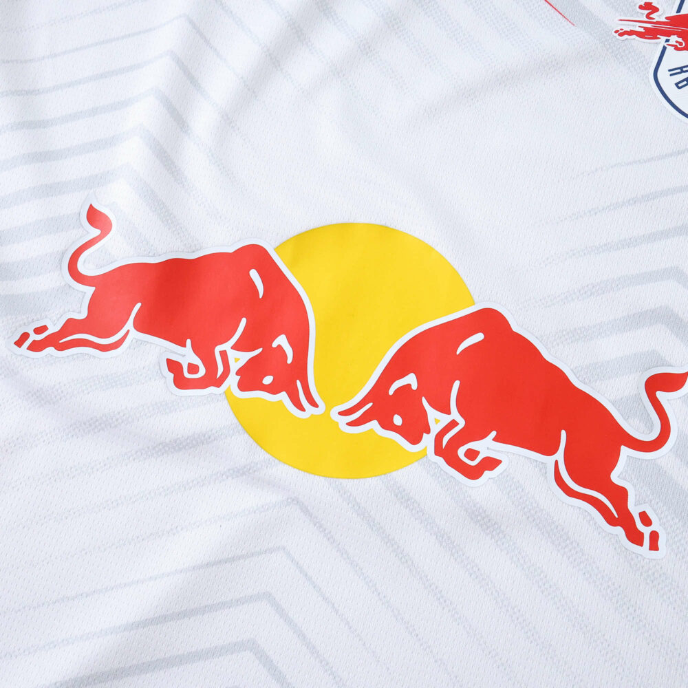 Close-up of RB Leipzig 2025/26 home fan jersey showing two red bulls with a yellow circle on white fabric.