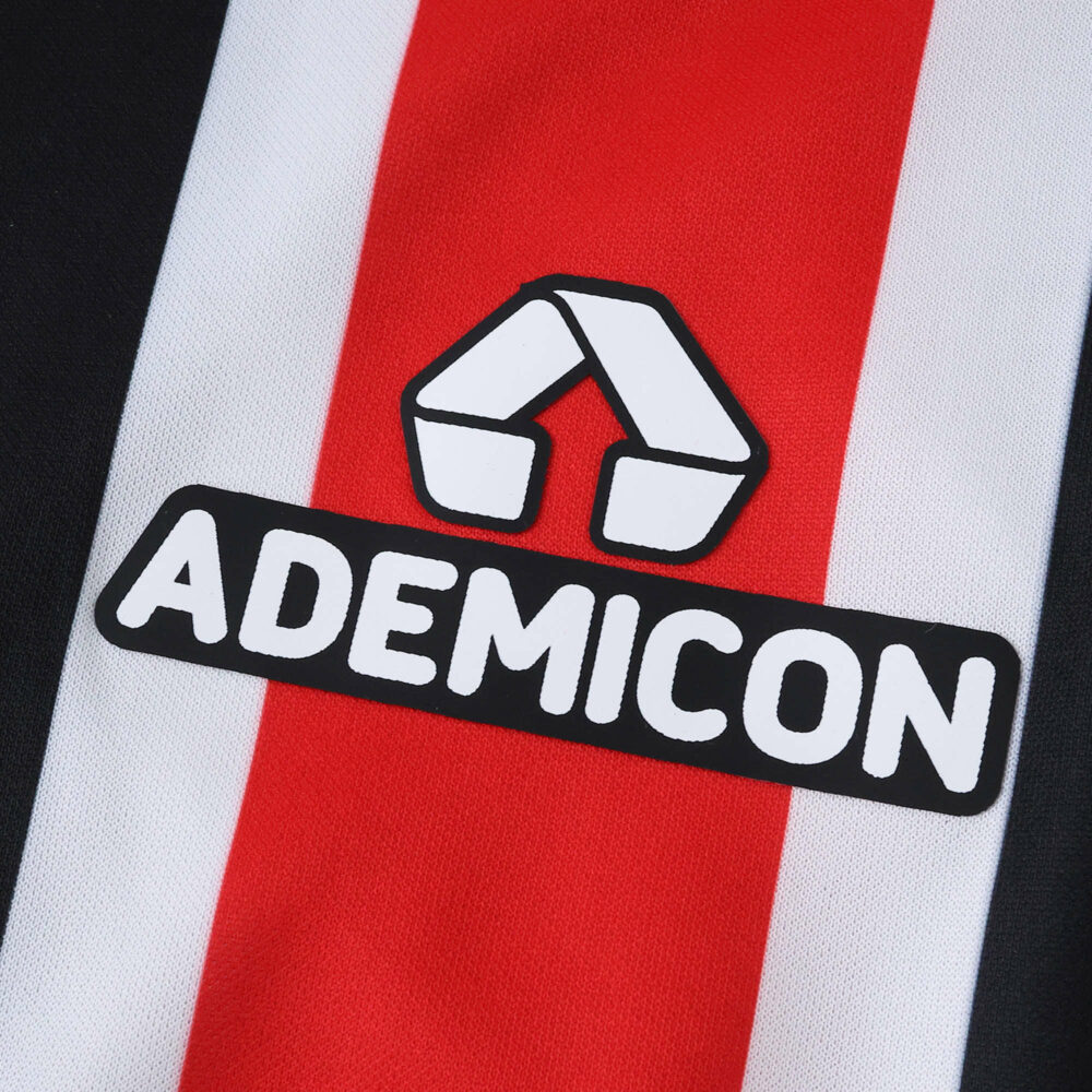 Close-up of São Paulo Away 2025/26 Fan Version jersey showing the Ademicon sponsor logo on red and white stripes.