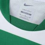 Close-up of the collar and tag inside the Sporting CP 2025/26 home fan jersey featuring green and white colors.