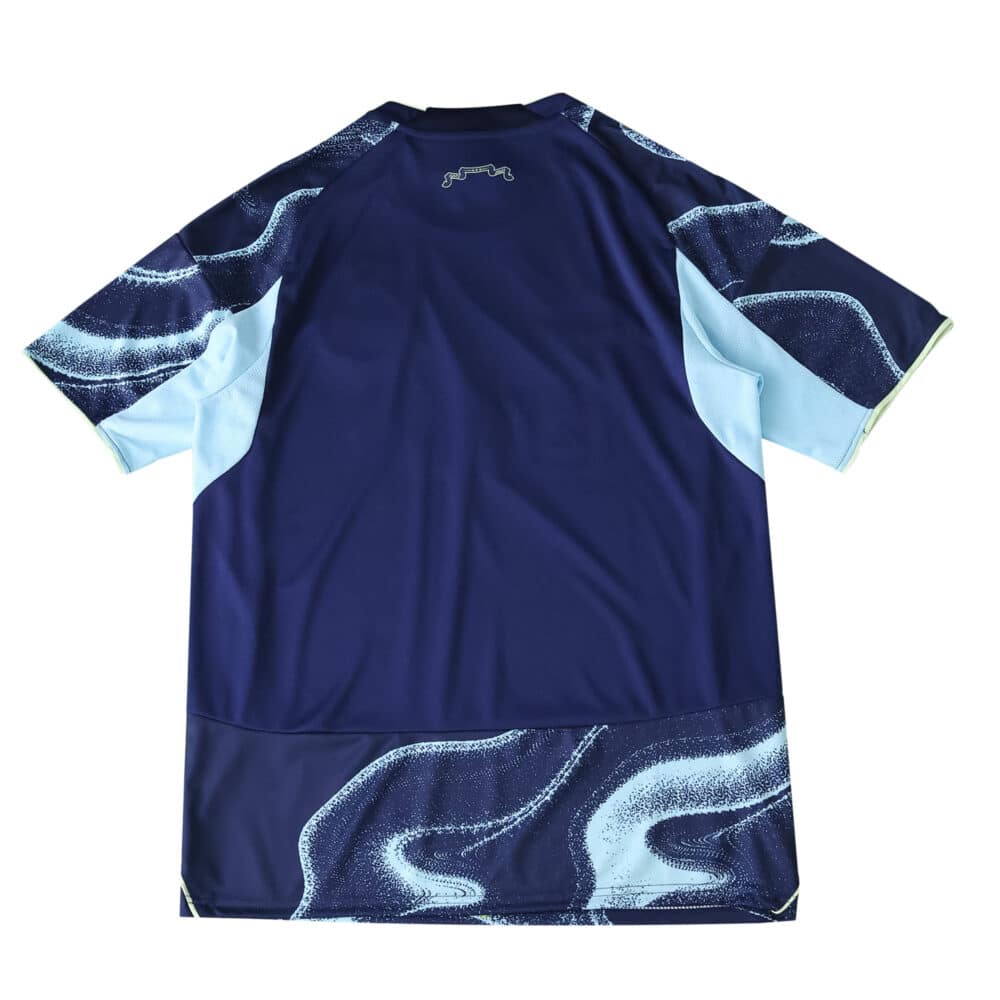 Back view of the Ajax Away 2025/26 Fan Version jersey featuring dark blue with light blue and white swirl patterns.