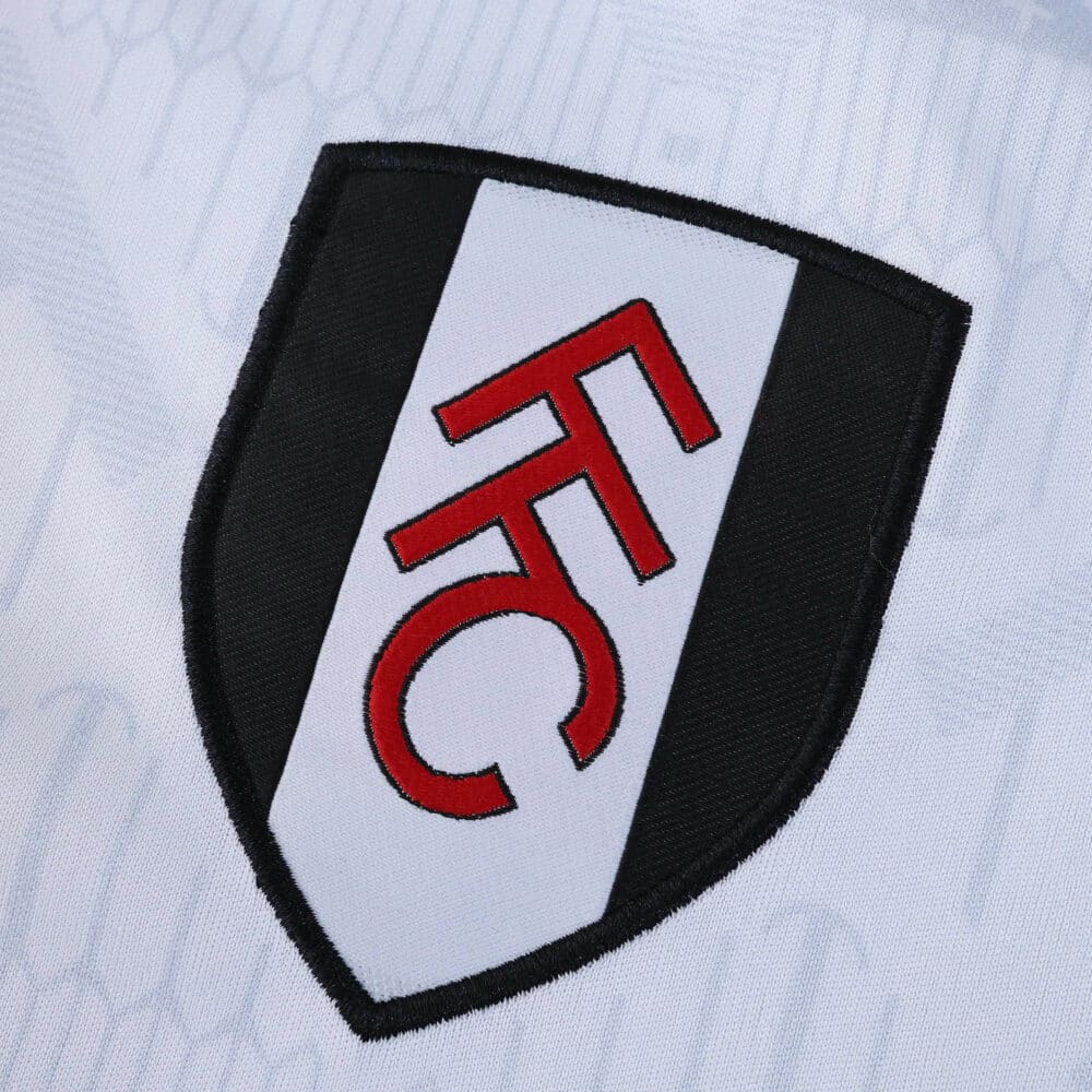 Close-up of Fulham FC crest on the 2025/26 Fan Version home jersey fabric.