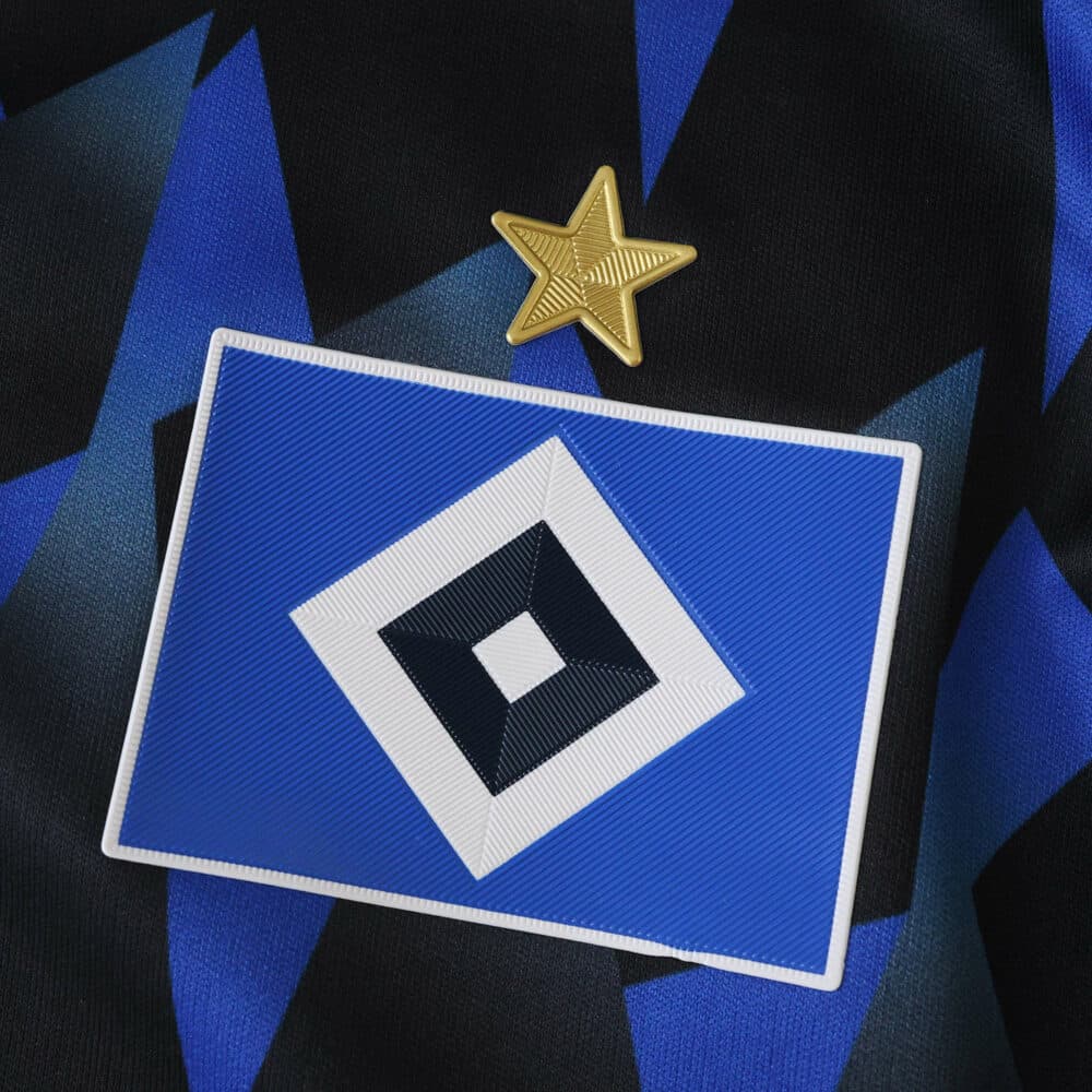 Close-up of the Hamburger SV 2025/26 home fan jersey badge with a gold star above the club crest.