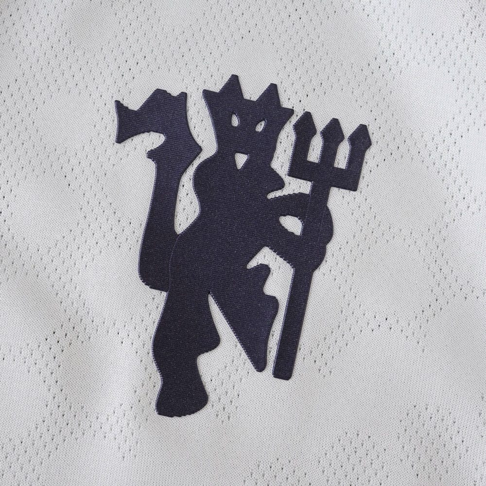 Close-up of the Manchester United crest on the 2025/26 Away Player Version jersey.