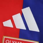 Close-up of the Adidas logo on the Olympique Lyonnais 2025/26 Home Player Version jersey.