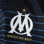 Olympique Marseille 2025/26 away player jersey featuring club crest and "Droit Au But" motto.